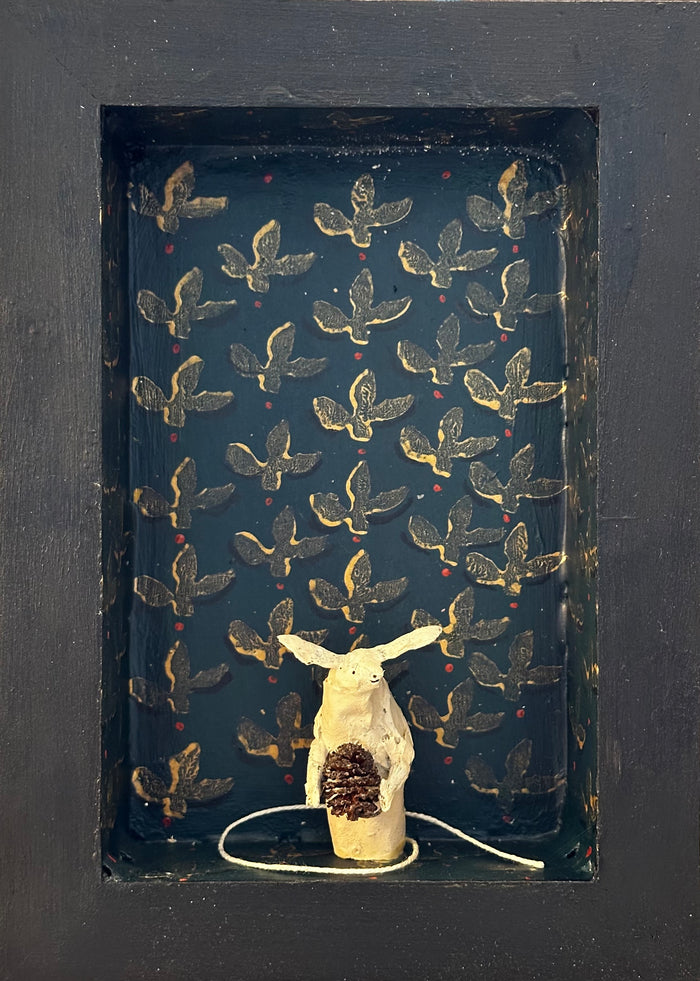 Mouse with alder cone in blue room